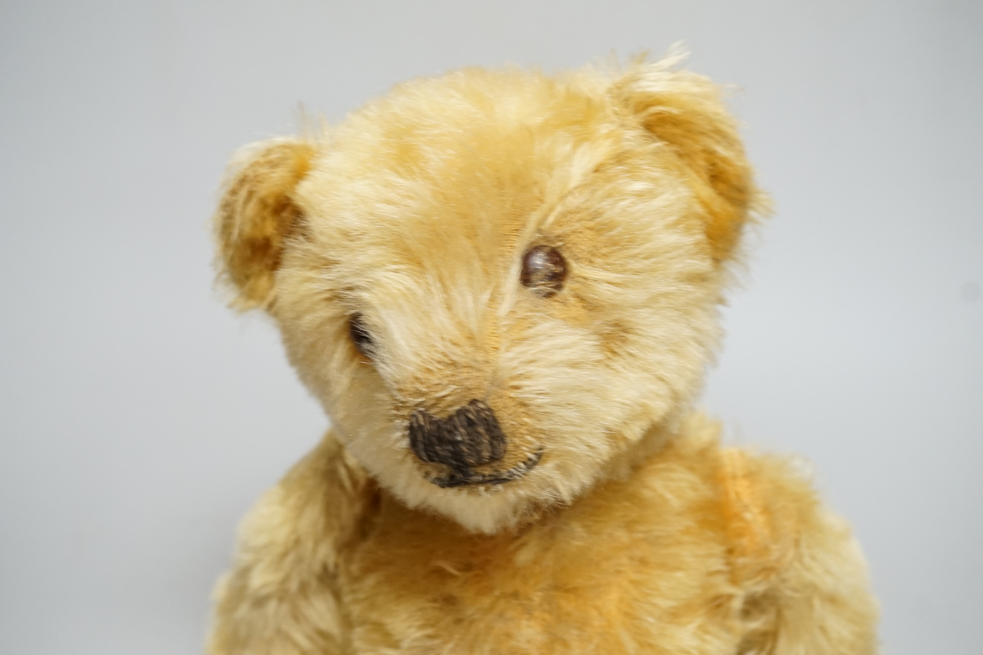 A Deans 1950's mouse eared bear, label on left foot, 16in., repair to paw pads, good mohair